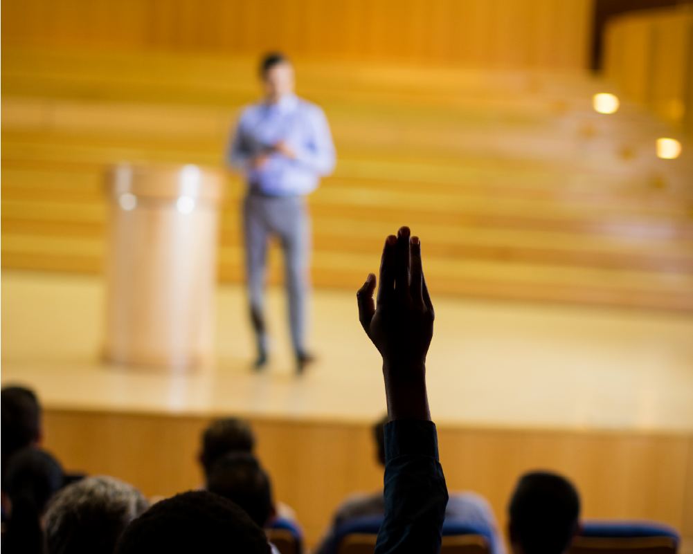 Speaker on stage with engaged audience